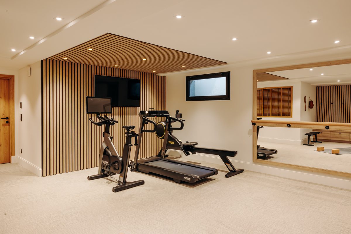 The Holisty villa's gym on the garden level: Technogym treadmill, bike and rowing machine