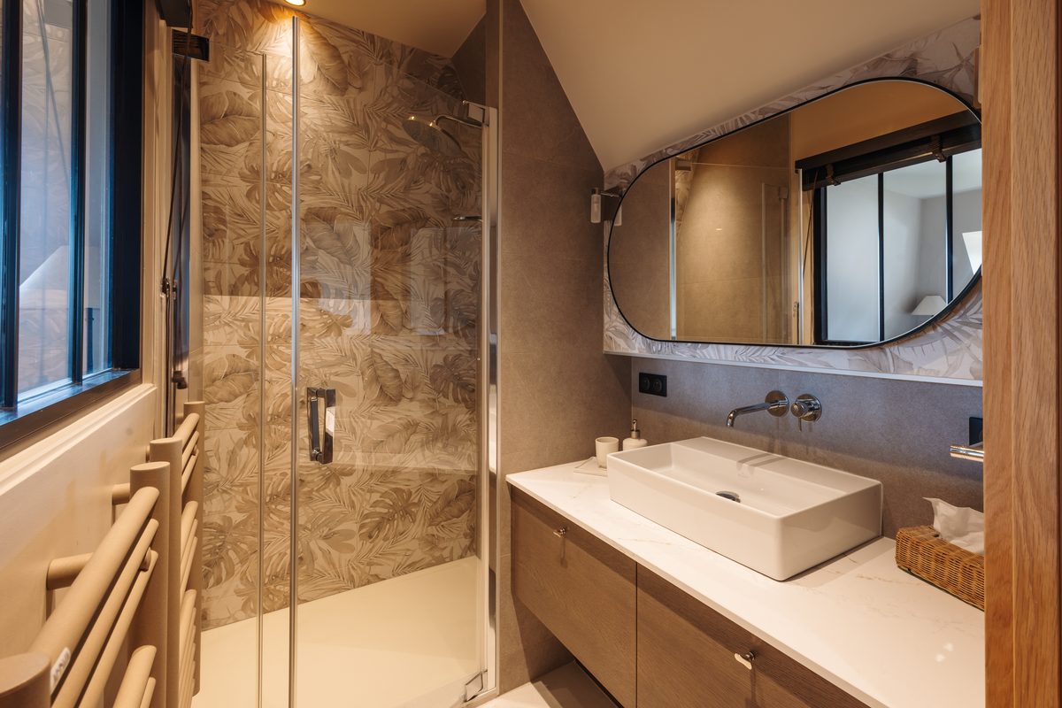 Villa bathroom in dark marble, basin and mirror
