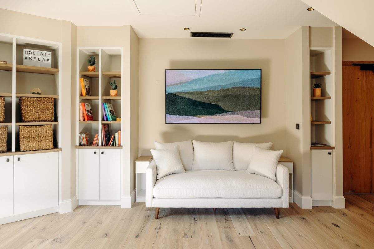 The villa's small TV lounge, sofa and Samsung The Frame screen