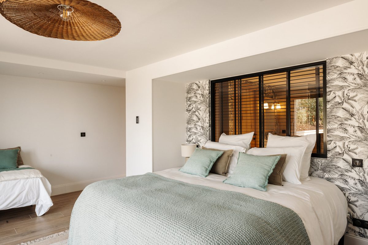 Suite 6 and its headboard with floral wallpaper