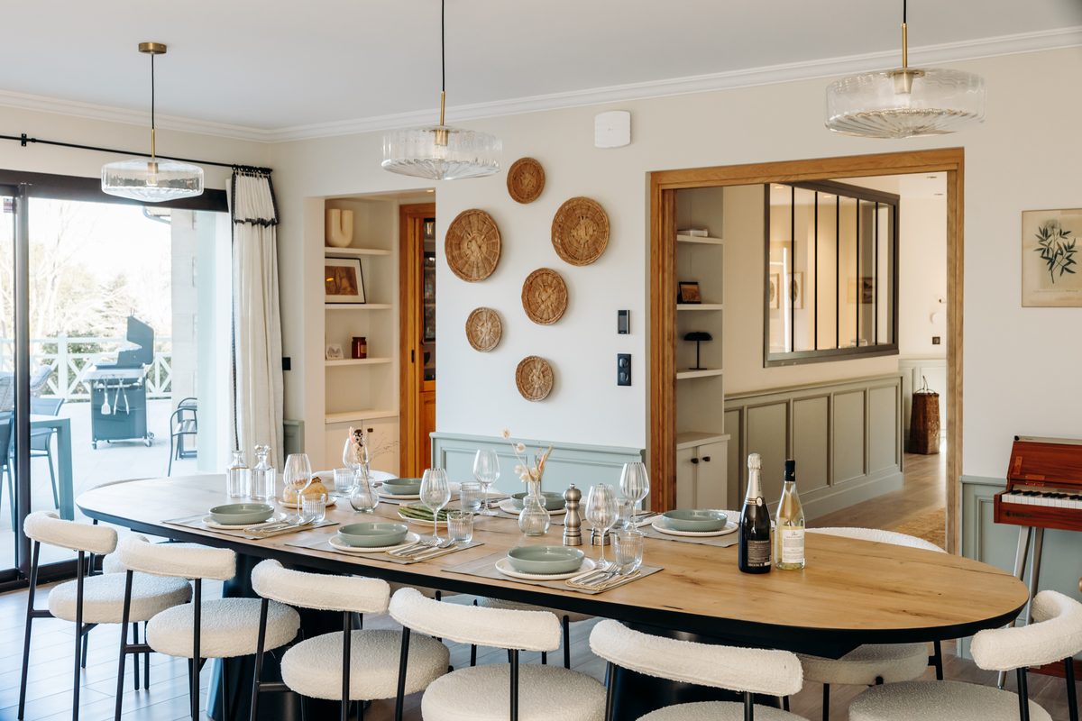 The large dining table, laid for fourteen guests